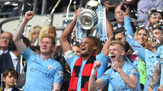 Vincent Kompany of Manchester City lifts the FA Cup Trophy