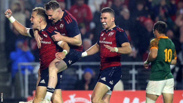 Mike Haley celebrates scoring one of Munster's four tries with Rory Scannell and Shane Daly