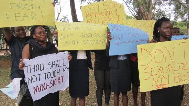 Uganda women hold banners