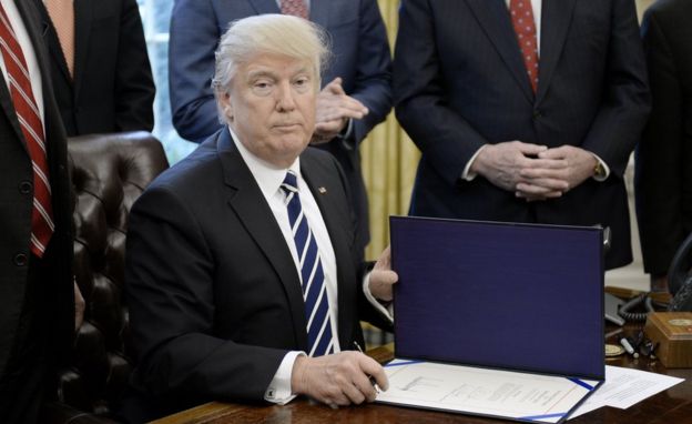 President Donald Trump signs H.J. Res. 41 in the Oval Office of the White House on 14 February, 2017 in Washington, DC.