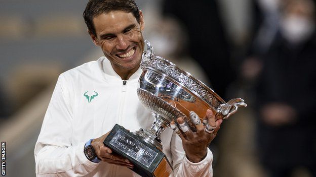 Rafael Nadal smiles with the French Open trophy