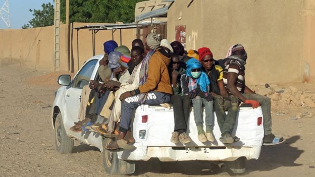 Migrants on a pick-up truck