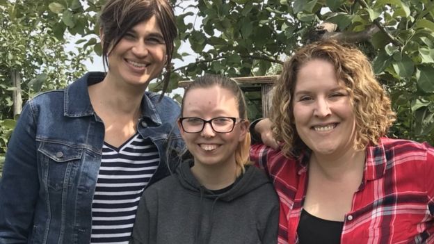 Ashley, Zoe and Amanda smiling as they pose for a photo together