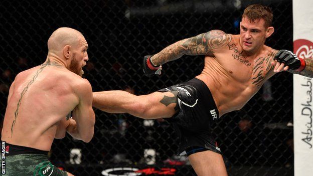 Dustin Poirier kicks Conor McGregor during their rematch at UFC 257