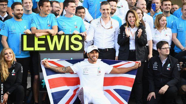 British driver Lewis Hamilton celebrates a fifth world title