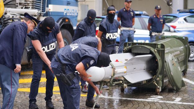 Italian police with missile seized in raids on far-right groups