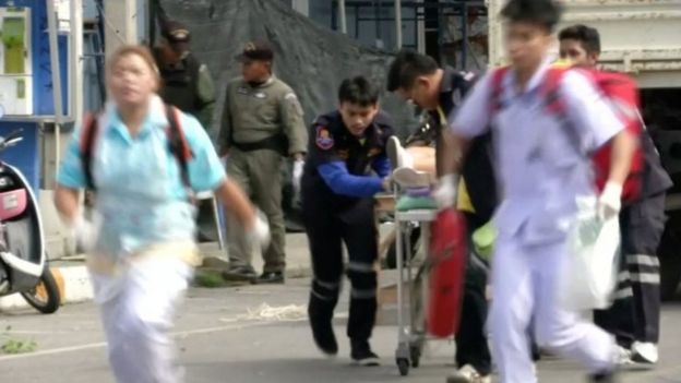 Rescuers and medical officers push an injured person on a gurney at the site of a bomb blast in Hua Hin, south of Bangkok, Thailand,