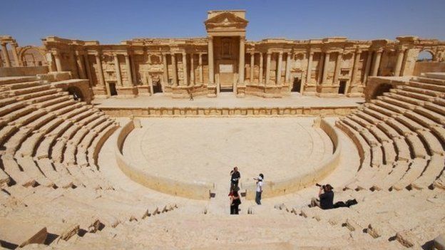 Tourists take pictures at the ancient Palmyra theatre in the historical city of Palmyra on 18 April 2008.