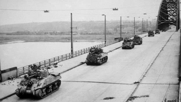 Allied Sherman tanks crossing the newly-captured bridge at Nijmegen in Holland during their advance as part of Operation Market Garden