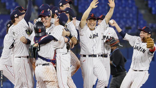 Japan's baseball team celebrate winning gold in men's baseball