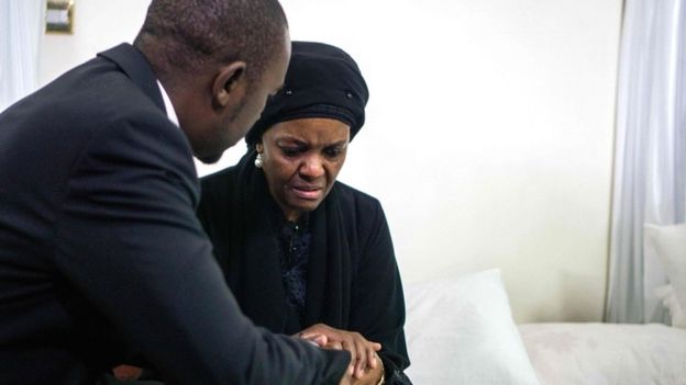 Movement for Democratic Change opposition party leader Nelson Chamisa (L) offers his condolences to Zimbabwe's former first lady Grace Mugabe, as the body of late president Robert Mugabe lies in state at the Mugabe"s residency in Harare on September 12, 2019