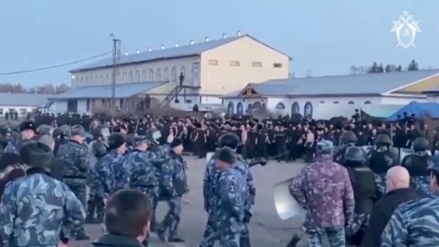 A still image taken from a video released by the Investigative Committee of Russia, showing inmates standing by guards