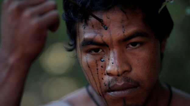 Paulo Paulino Guajajara applies face paint in September