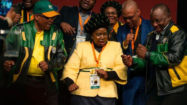 South African President Jacob Zuma (L), former African Union Chairperson and presidential hopeful Nkosazana Dlamini-Zuma (C) and South African Deputy President Cyril Ramaphosa (R) dance after the closing session of the South African ruling party African National Congress (ANC) policy conference on July 5, 2017 in Johannesburg, South Africa