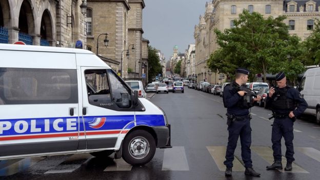 French police officials gather at the entrance to Notre-Dame Cathedral