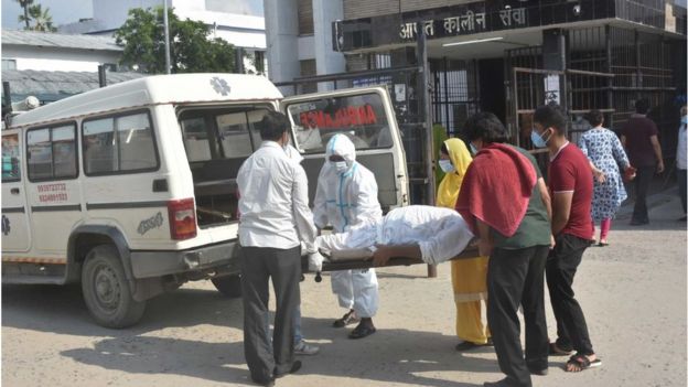 People next to suspected Covid-19 patient seen without PPE gear at Nalanda Medical College and Hospital campus -- designated Covid-19 hospital, on July 22, 2020 in Patna, India.