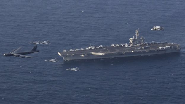 A handout photo made available by the US Navy shows the Abraham Lincoln Carrier Strike Group and a US Air Force B-52H Stratofortress, assigned to the 20th Expeditionary Bomb Squadron and part of the Bomber Task Force deployed to the region, conducting joint exercises in the US Central Command area of responsibility, in the Arabian Sea (1 June 2019)