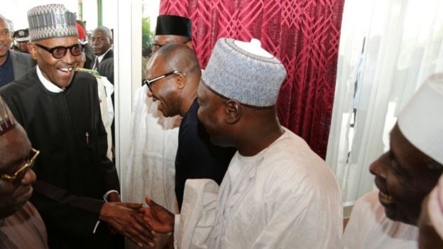 Nigeria's President Buhari laughs with state officials