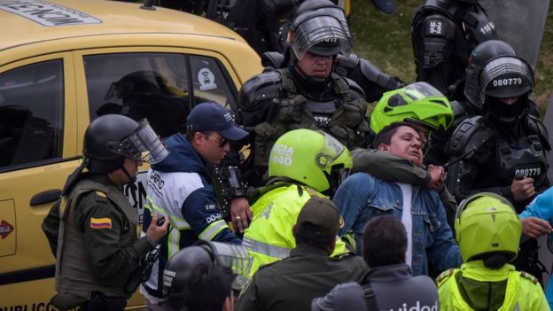 Police arrest a taxi driver during a protest against the private hire company Uber in Bogota, 23 October 2017