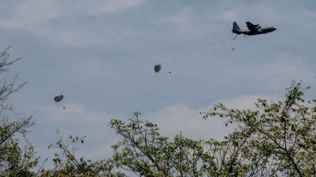 Avião e paraquedistas saltando