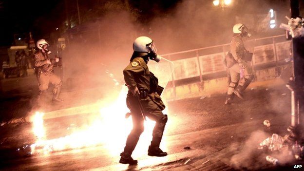 Riot policemen chase protesters in Athens, July 2015