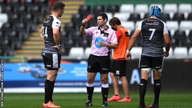 George North of Ospreys is shown a red card by Referee Adam Jones