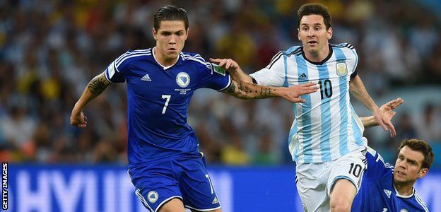 Lionel Messi of Argentina takes on Muhamed Besic of Bosnia and Herzegovina at the 2014 World Cup