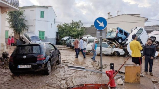 Cars are piled up on top of each other in a muddy street