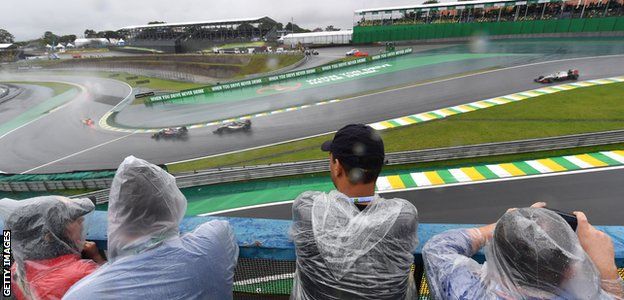 Brazilian Grand Prix fans watch at Interlagos in the rain