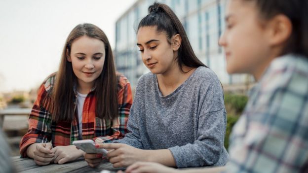 Teenagers looking at phone