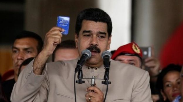 Venezuela's President Nicolas Maduro holds a copy of the Venezuelan constitution as he speaks during a gathering outside the National Electoral Council (CNE) where he presented his proposal to set up a National Constituent Assembly, in Caracas, Venezuela May 3, 2017.