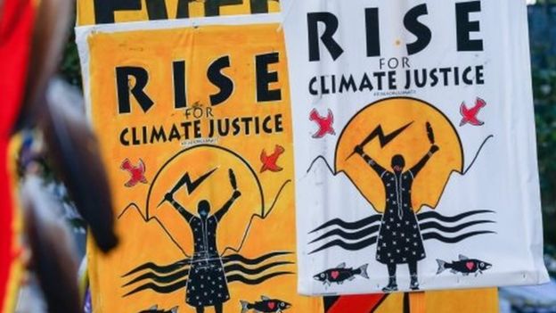 Signs saying "Rise for climate justice" are seen in San Francisco, California, USA on 8 September 2018