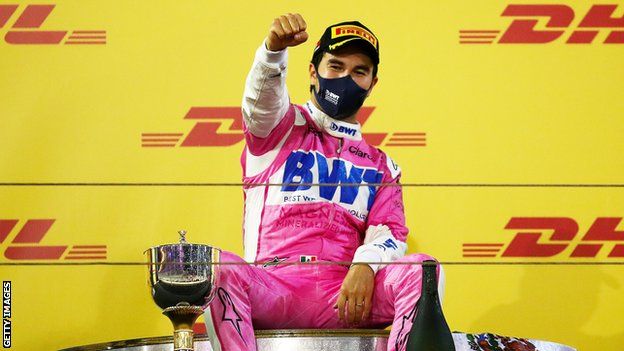 Racing Point driver Sergio Perez celebrates on the podium after winning the 2020 Sakhir race in Bahrain