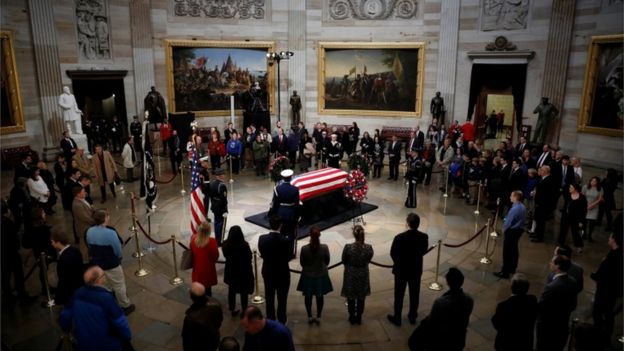 Mourners pay their respects at the casket of former U.S. President George H.W. Bush as it lies in state inside the U.S. Capitol Rotunda on Capitol Hill