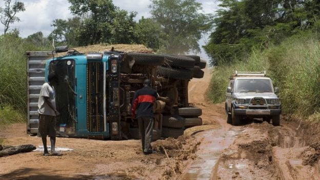 A truck flips over on a muddy road in Sudan