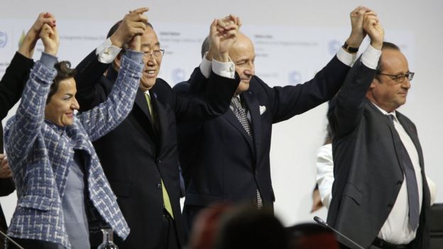 UN Secretary General Ban Ki-moon, French Foreign Minister Laurent Fabius and French President Francois Hollande celebration the adoption of the Paris agreement