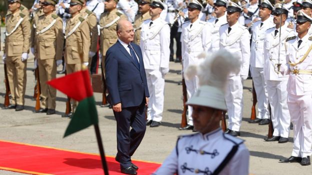 Barham Saleh reviews an honour guard during a presidential handover ceremony in Baghdad on 3 October 2018