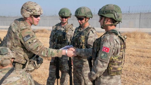 In this handout provided by the U.S. Army, U.S. and Turkish military forces conduct the third ground combined joint patrol inside the security mechanism area in northeast Syria, Oct. 4, 2019.