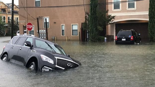 A vehicle partially submerged by floodwaters in Houston