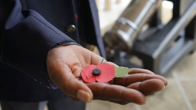 An ex-serviceman holds a poppy