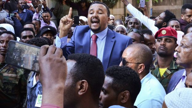 Jawar Mohammed (C), a member of the Oromo ethnic group who has been a public critic of Abiy, addresses supporters that had gathered outside his home in the Ethiopian capital, Addis Ababa after he accused security forces of trying to orchestrate an attack against him October 24, 2019