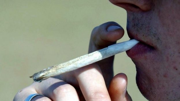 A man smoking a cannabis joint