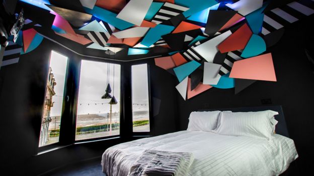 A light installation on the ceiling of artist Mark McClure's room brings the Blackpool illuminations indoors