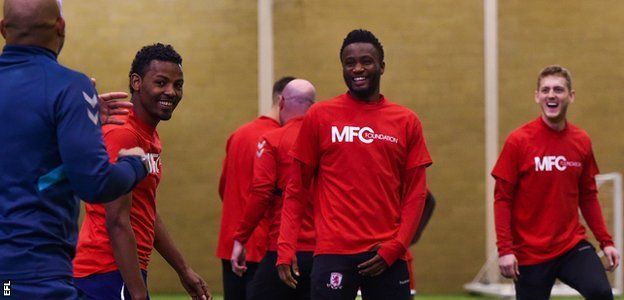 John Mikel Obi laughs with Middlesbrough team-mates and Club Together refugee players