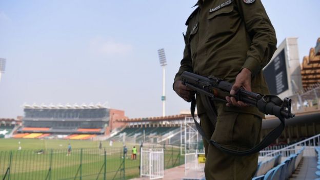 A Pakistani policeman stands guard while national cricket team players take part in a practice session at the Gaddafi Cricket Stadium in Lahore on 8 September 2017, for the forthcoming World XI tour to Pakistan