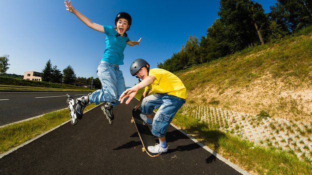 children roller skating and skateboarding