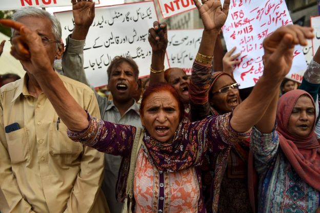 Supporters of Home Based Women Workers Federation (HBWWF) shout slogans against the 2019 national budget and the International Monetary Fund (IMF) during a protest in Karachi on July 6, 2019, after prices were hiked