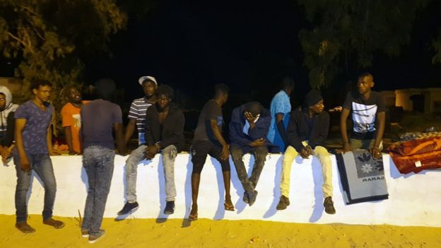 People gather outside the Tajoura Detention Centre after an air strike kills nearly 40 migrants east of Tripoli, 3 July