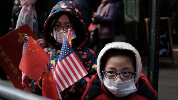 US children wear masks during a Lunar New Year Parade in New York's Chinatown earlier this month