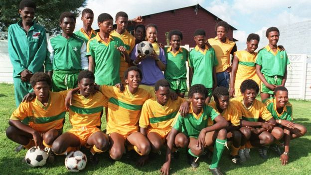 Members of the Mandela United Football Club team pose with Zinzi Mandela-Hlongwane (holding ball) outside Mandela's residence in Soweto in early January 1987.